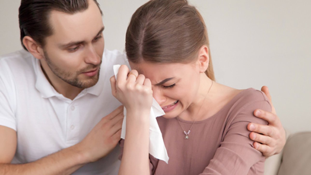 Upset crying woman wiping tears with handkerchief, loving boyfriend trying to comfort girlfriend embracing her, husband consoling depressed wife, support in difficult situation, compassion