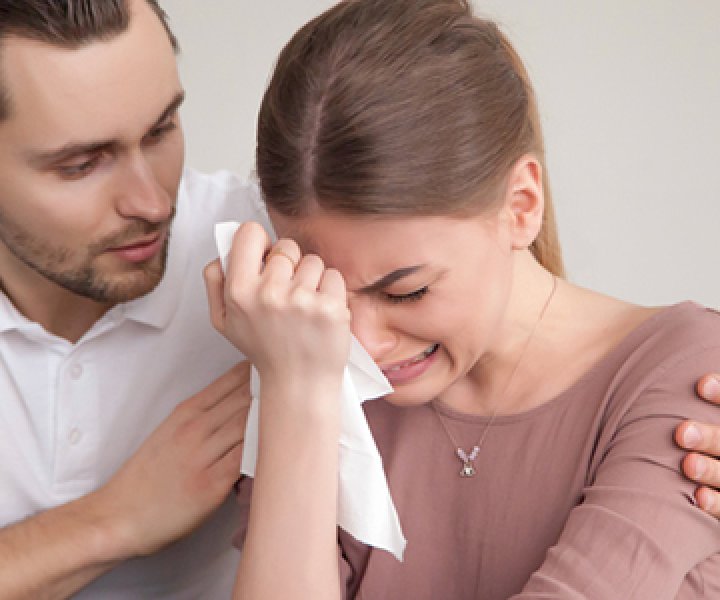 Upset crying woman wiping tears with handkerchief, loving boyfriend trying to comfort girlfriend embracing her, husband consoling depressed wife, support in difficult situation, compassion